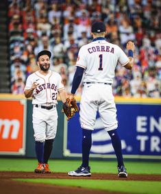 two baseball players are standing on the field