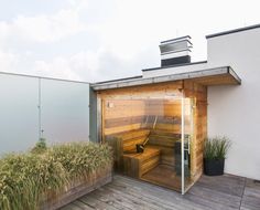 an outdoor sauna is shown on the roof of a house with grass growing around it