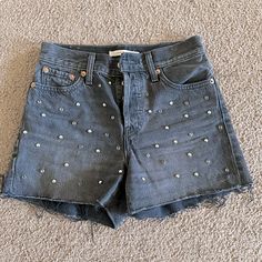 Step Up Your Festival Game With These Levi's Women's Wedgie Jean Shorts. The Studded Rhinestone Embellishments Add A Touch Of Sparkle To The Classic Denim Cut-Off Style. These Shorts Are Perfect For Casual Occasions And Come In A Size 26 With A Mid-Rise Fit. The 5-Pocket Design And Flat Front With A Regular Fit Make Them Comfortable For Walking Or Any Other Activity. They Are Made Of 100% Cotton With A Dark Wash And Can Be Machine Washed For Easy Care. These Shorts Are Perfect For The Summer, Fa Black Rhinestone Short Bottoms, Black Rhinestone-embellished Short Bottoms, Black Rhinestone Embellished Short Bottoms, Levis Wedgie Jeans, Shorts Levis, Festival Games, Wedgie Jeans, Rhinestone Embellishments, Levis Women