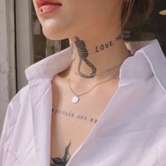 a woman with tattoos on her neck and chest