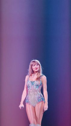 a woman in a bodysuit walking on a stage with her legs spread wide open