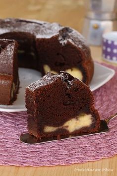 a chocolate cake on a plate with one slice cut out