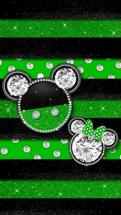 two mickey mouse heads with green and black stripes on them, one has a bow