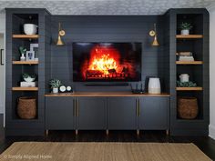 a living room with a fire place in the center and shelves on either side that are open