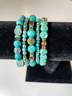 Handpicked Gems and Beads, Crafted into Stunning Stacks: Each piece is meticulously designed and handcrafted with love, ensuring that you receive truly unique and extraordinary accessories. These bracelets are carefully curated to showcase a harmonious blend of colors, textures, and styles. All bracelets are approximately 7.5 inches in length. This stack showcases gorgeous, eye-catching colors of turquoise and gold. Elevate your everyday style with this stunning bracelet stack.✨ #bracelets #jewelry #accessories #handmade #fashion #style #instajewelry #wristcandy #armcandy #jewelryaddict #fashionista #shopsmall #supportlocal #giftideas #braceletstacks #uniquebracelets #handcraftedjewelry #oneofakind #bohostyle #minimalistjewelry #statementjewelry #layeredlook #stackedbracelets #trendyjewelr Unique Turquoise Beaded Bracelets, Elegant Handmade Turquoise Stretch Bracelet, Turquoise Bracelets With Faceted Beads For Gift, Turquoise Faceted Beads Stretch Bracelet As Gift, Turquoise Wrap Bracelet With Faceted Beads As Gift, Unique Adjustable Turquoise Beaded Bracelet, Turquoise Stretch Bracelet With Round Beads, Turquoise Stackable Stretch Bracelet With Round Beads, Turquoise Stretch Bracelet With Stackable Round Beads