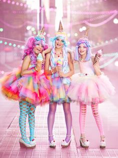 three girls dressed up in costumes posing for the camera