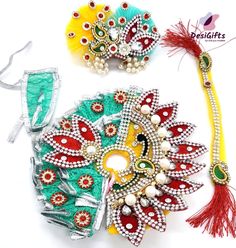 two pieces of colorful hair accessories on a white surface, one with beads and the other with feathers