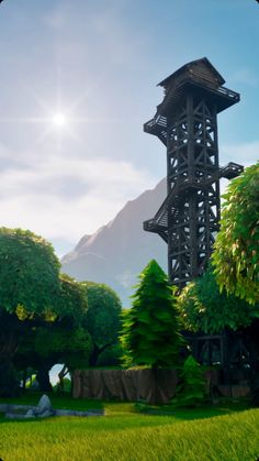 a tall tower sitting in the middle of a lush green forest next to a mountain