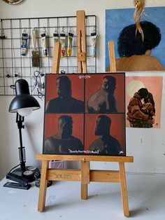 an artist's easel with paintings on it