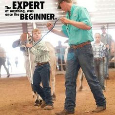 a man teaching a boy how to rope a cow