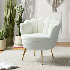 a white chair sitting on top of a rug next to a potted cacti