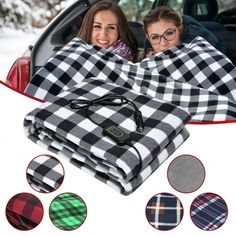 two women wrapped up in plaid blankets sitting next to each other on the back of a car