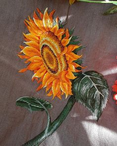 a sunflower painted on a piece of cloth