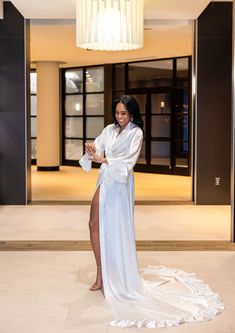 Glimmer as you grace the bridal suite in this elegant cathedral length robe. Crafted from satin, this high-end piece is both washer and dryer friendly, though light steaming is recommended for a perfect presentation upon opening. Available in Missy (Size 0-10), Plus (Size 12-16) and Curve (Size 18-22) White. Stylish Bridal Party Robes in Blush Pink, Sienna, Emerald Green, and Champagne are also available. Quick Ship Collection. Ships in 5-7 business days! January 2024 Outfits, White Bridal Robe, Organza Bridal, Curve Hugging Dress, Bridal Shower Inspo, Curvy Bride, Bridal Party Robes, Bridal Robe, Wedding Robe