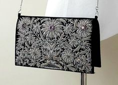 Embrace your dramatic side with this dazzling, opulent black velvet evening bag clutch, exquisitely hand embroidered with antique silver tone metallic threads, silk, and studded with genuine cut amethyst stones, aqua chalcedony and onyx to create an extravagant textured 3D effect. It catches the light in the most alluring way. Add glamour and elegance to any ensemble! Style it with an evening gown or be revel and wear it with a motorcycle jacket and leather pants - it works with every style!Insp Floral Clutches, Amethyst Stones, Aqua Chalcedony, Embroidered Bag, Onyx Bead, Evening Clutch Bag, Gold Threads, Metallic Thread, Amethyst Stone