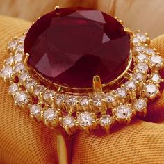 19.26 Carats Impressive Red Ruby and Diamond 14K Yellow Gold Ring Suggested Replacement Value $8,400.00 Total Red Ruby Weight is: 17.36 Carats (glass filled) Ruby Measures: 15.74 x 13.96mm Natural Round Diamonds Weight: 1.90 Carats (color G / Clarity VS2-SI1) Ring total weight: 11.6 grams Disclaimer: all weights, measurements and colors are approximate and may vary slightly from the listed dimensions or as seen in the image. All pictures are magnified to show the smallest of details. Please, ref Luxury Gia Certified Ruby Ring, Luxury Diamond Ruby Ring, Luxury Ruby Halo Ring, Luxury Ruby Ring With Diamonds, Luxury Ruby Ring With Vvs Clarity, Luxury Ruby Ring With Diamond In Yellow Gold, Luxury Ruby And Diamond Ring In Yellow Gold, Luxury Oval Ruby Ring For Formal Occasions, Luxury Brilliant Cut Ruby Ring