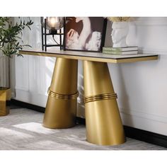 a table that has some gold legs on it