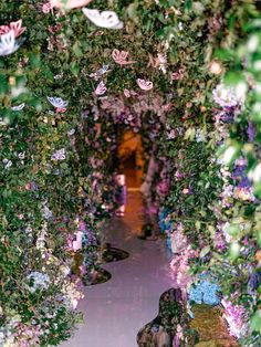 an archway covered in lots of purple flowers