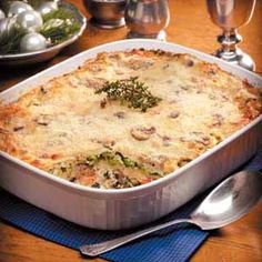 a casserole dish with broccoli and cheese in it on a table