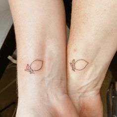 two people with matching tattoos on their arms