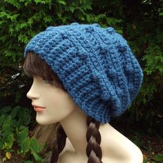 a mannequin head wearing a blue knitted hat