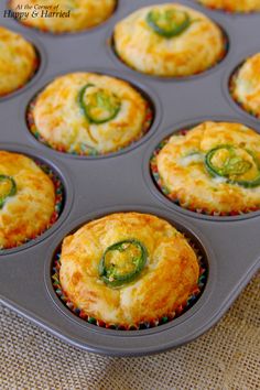 a muffin tin filled with mini jalapeno pop cupcakes on top of a table