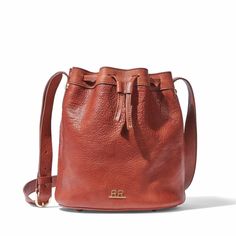 Our Petite Bucket Bag is handcrafted in luxuriously soft vegetable-tanned American leather. This stylish, versatile bag is cinched with a drawstring closure and includes an adjustable shoulder strap -- wear it on the shoulder or across the body. The interior is fully lined and includes a pocket to keep valuables within easy reach. Our leathers are carefully selected for their natural appearance and regenerative sourcing -- all our leathers come from rangelands managed with nature in mind. Variat Classic Crossbody Bucket Bag In Soft Leather, Classic Soft Leather Crossbody Bucket Bag, Versatile Leather Bucket Bag With Leather Lining, Classic Crossbody Bucket Bag With Leather Lining, Leather Bucket Bag With Leather Lining For Errands, Classic Leather Lined Crossbody Bucket Bag, Elegant Leather Bucket Backpack With Adjustable Strap, Leather Drawstring Bag With Adjustable Strap For Travel, Everyday Crossbody Drawstring Bag With Adjustable Strap