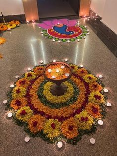 a decorated floor with candles and flowers on it