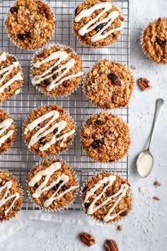 several muffins with icing on a cooling rack