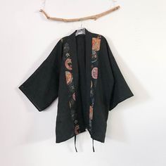 "made to order round floral motif on black heavy weight linen haori inspired jacket choose width 50\" or 60\" at check out material: heavy weight linen ( black) Japanese dobby cotton with round floral motif displaying on the front right and left strips and the center on the back design: haori inspired handmade jacket 2 strings to tie in the front/ meant to wear with a little gap in the center front kimono wide sleeves bust 58\"- 60\" room length 35\" around you can find coat length haori jacket Black Bohemian Cotton Outerwear, Traditional Black Cotton Kimono, Black Cotton Kimono With Kimono Sleeves, Traditional Black Kimono For Fall, Traditional Black Fall Kimono, Black Kimono With Floral Embroidery, Black Floral Embroidered Kimono, Black Kimono With Floral Embroidery For Fall, Black Floral Embroidered Kimono For Fall