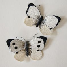 two crocheted butterflies with black and white wings