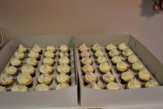 two boxes filled with cupcakes sitting on top of a counter