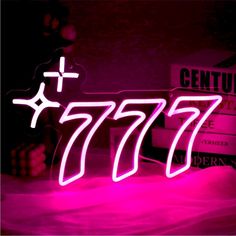 a neon sign that reads 777 with the word genius underneath it