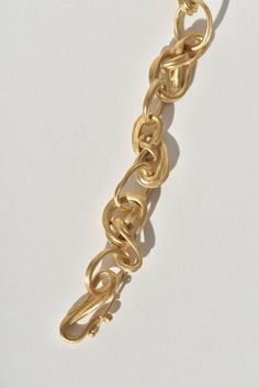 Noeud- which means knot in French- was a clear inspiration for this bracelet. After months of developing her ability to work with this special wax, some of the most successful forms- such as the ones found in this bracelet- were achieved in a matter of minutes, when Leigh let the wax inform what it wanted to be. Uniquely knotted golden shapes are connected by individually crafted loops and finished with a hand-formed ‘S’ clasp to create a noteworthy statement bracelet. To design her inaugural fi Gold Satin, Statement Bracelet, Fine Jewelry Collection, Gold Polish, Miniature Art, Fashion Help, Makers Mark, To Work, Knot