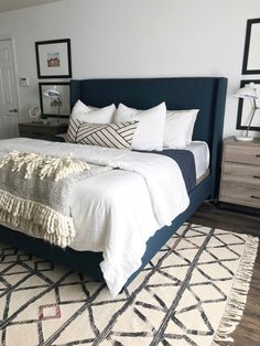 a bed with white sheets and pillows on top of it in a bedroom next to a dresser