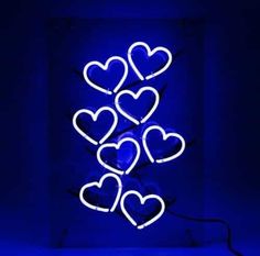 a blue neon sign with hearts on it