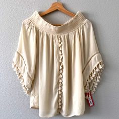 Cream Colored Boho Top. Nwt. Tassels On Front And Sleeves. Looks Like Off The Shoulder Neckline. Smoke And Pet Free Home! Beige Peasant Top For Summer Vacation, Chic Cream Top For Festival, Cream Peasant Top For Summer Vacation, Cream Peasant Top For Summer Beach, Cream Peasant Top For Beach Summer, Summer Cream Peasant Top For Beach, 70’s Style, Lace Tunic Tops, Red Tunic