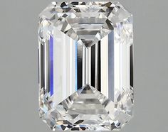 an emerald cut diamond on a gray background