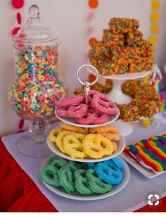 a table topped with lots of different types of donuts and sprinkles