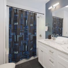 a bathroom with a blue shower curtain and white counter top next to a bathtub