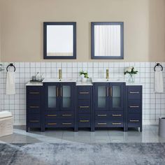 a bathroom with two sinks and mirrors on the wall