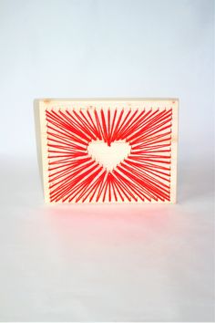 a red and white box with a heart drawn on it