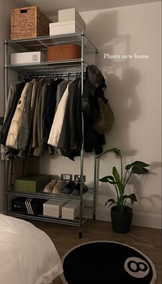 a closet with clothes and shoes hanging on the wall next to a bed in a bedroom