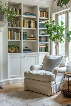 a living room with white furniture and bookshelves