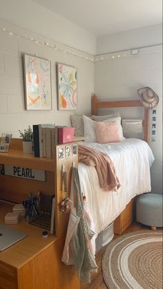 a bedroom with a bed, desk, and rugs on the floor in front of it