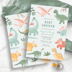 two baby shower cards with dinosaurs on them