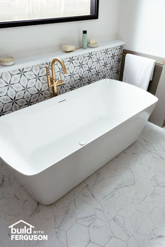 a white bath tub sitting next to a window