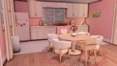 a kitchen with pink walls and white chairs around a round dining table in the center