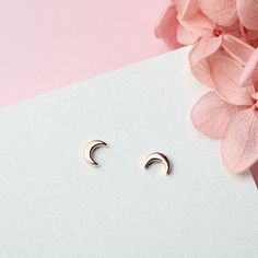 This pair of tiny crescent moon stud earrings is made of authentic 925 sterling silver, highly polished for a great shine. Experience the subtle elegance and beauty of these tiny sterling silver moon stud earrings, handcrafted from 925 sterling silver and polished to perfection. Each pair is a stunning addition to any outfit, adding a touch of celestial charm that will draw compliments and elevate your style. With their high-quality construction and brilliant shine, these earrings are a must-hav Elegant Crescent Silver Cartilage Earrings, Elegant Silver Crescent Cartilage Earrings, Crescent Sterling Silver Cartilage Earrings As Gift, Minimalist Rose Gold Sterling Silver Ear Climbers, Sterling Silver Cartilage Earrings With Moon Charm For Gift, Minimalist Moon-shaped Sterling Silver Cartilage Earrings, Sterling Silver Crescent Cartilage Earrings With Moon Charm, Minimalist Half Moon Earrings For Gift, Dainty Moon-shaped Sterling Silver Earrings