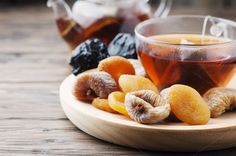 tea and dried fruits on a wooden table